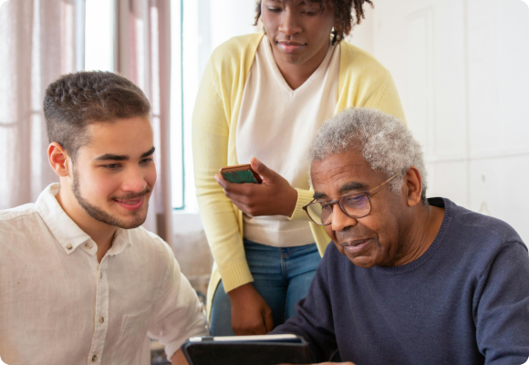 adult male helping an older black male with a tablet in a therapy setting